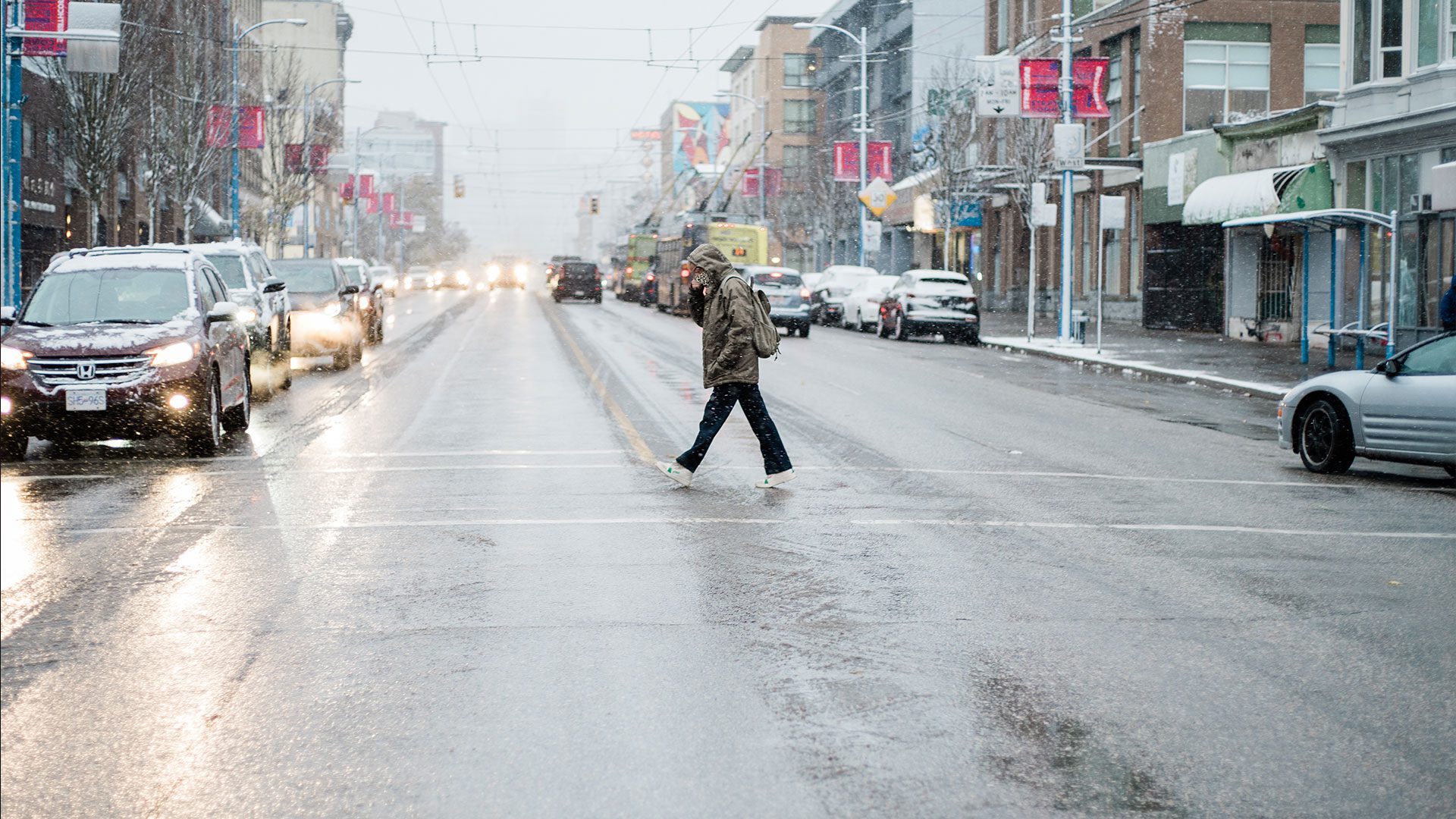 man crosses street in Vancouver 
