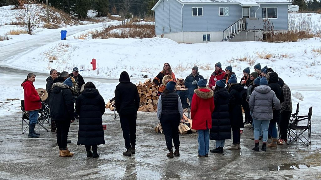 Students stand around sacred fire at Williams Lake First Nation