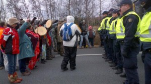 A line of Mi'kmaq and their supporters confront a line of RCMP officers on Hwy 11 Thursday.